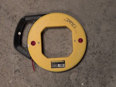 a close up of a yellow circular device on a concrete floor