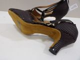 pair of women ' s shoes on a table with a tag on it