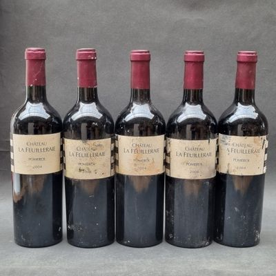 four bottles of wine are lined up on a table
