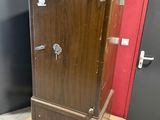 a wooden cabinet that is on a pallet in a room