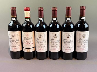 six bottles of wine are lined up in a row on a table