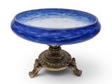 an image of a blue glass bowl sitting on top of a metal stand