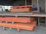 a pile of wood sitting on a pallet in front of a building