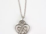 a heart shaped pendant with two intertwined hearts on a ball chain