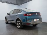the rear end of a blue car parked in a garage