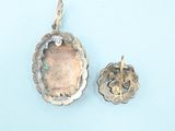 two pieces of silver on a blue surface