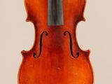 an old violin with a bow hanging from it ' s back
