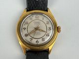 a close up of a wrist watch on a white surface