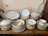 a lot of plates and bowls on a wooden table