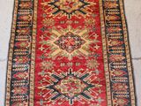 an old rug hanging on a wall in a room