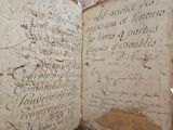 an old book with writing on it sitting on a table