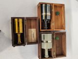 three wooden boxes that have different types of wine in them