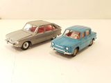 two toy cars sitting next to each other on a table