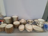 a lot of plates and bowls on the table