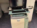 a computer sitting on top of a printer in a room