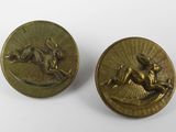 a pair of brass buttons with a horse and rider on them