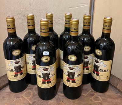 six bottles of wine are lined up on a counter top