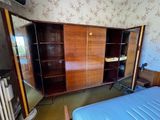 a bedroom with a bed and a cabinet in it