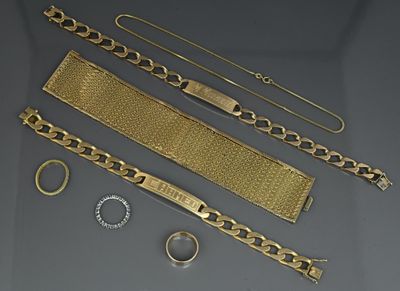 several pieces of gold jewelry including a bracelet, bracelet, and ring