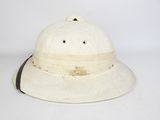 a white hat with a black ribbon around it