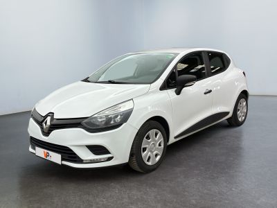 a white car is parked in a room with a black floor