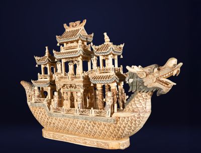 carved wooden model of a boat with a dragon on the front