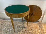 a small table with a green top next to a round table with a star on it