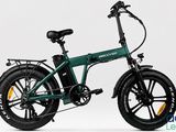 an image of a green electric bike with a black tire on a white background