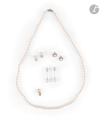 a close up of a necklace and earring set on a white background