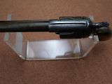 a gun that is sitting on top of a clear box