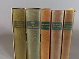 four books are lined up in a row on a table