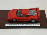 a red model of a car on display on a table