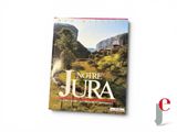 a book with a picture of a mountain in the background