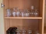 many glasses on the shelves in the kitchen
