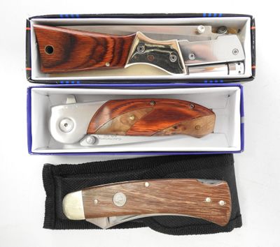 two knives in a box on a white surface