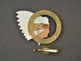 a gold pin with a picture of an angel on it