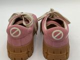 pink and white sneakers with a peace sign on the sole