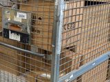 a metal cage with a bunch of boxes in it