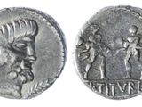 a close up of a silver coin with a man and woman on it