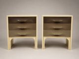 a pair of nightstands with two drawers on each side