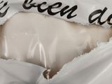 a piece of cheese in a bag with a price tag on it