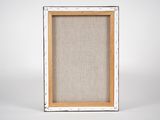 a white picture frame with a linen backing and wood trim