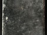 a metal plate with a hole in it on a black surface