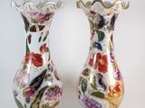 two vases sitting side by side on a white surface