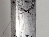 a knife that has been engraved with a coat of arms on it