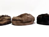 three hats are lined up in a row on a white surface