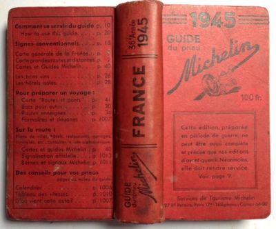 a red book that is open on a white table