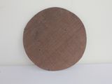 a brown disc on a white surface with a white background