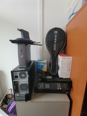 a stack of electronics on top of a refrigerator in a room