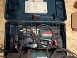 a box with a drill and other tools inside of it